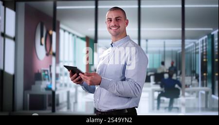 Business Man Holding Tablet Computer In Office Stock Photo