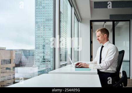 Busy businessman financial analyst or manager using computer at work. Stock Photo