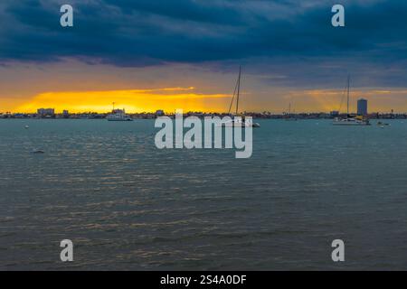 Captured from Fort De Soto Park, the Sunshine Skyway Bridge stands proudly over Tampa Bay, bathed in the brilliant colors of an early morning sunrise. Stock Photo