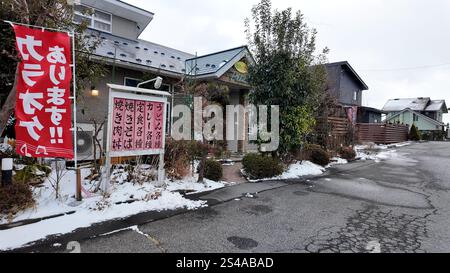 January 9, 2025: A restaurant on a cold evening on a snowy winter day in Komagane City, Nagano Prefecture. Stock Photo
