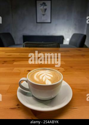 This photo captures the essence of a quiet spring day in Istanbul, with a creamy latte taking center stage. Served in a pristine white porcelain cup, Stock Photo