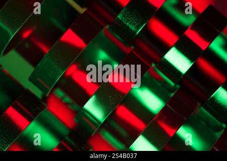 Abstract close up of plastic binder rings with reflections of red and green Stock Photo