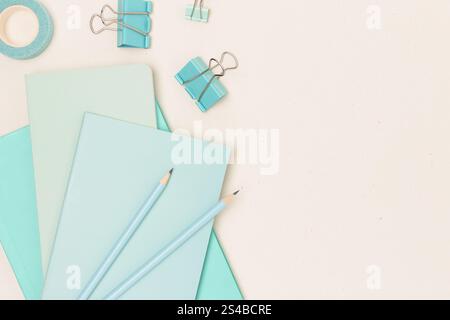 Mint colored school supplies on a beige background. Place for your design. Stock Photo