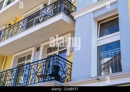 Open balcony house. Fasade wall home. Blue yellow color. Terrace Stock Photo