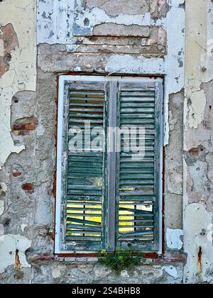 Wooden window shutter in derelict building Stock Photo