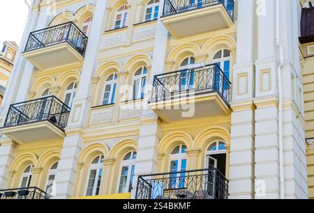 Yellow modern exterior of houses buildings. Windows balcony facade. Bright architecture Stock Photo
