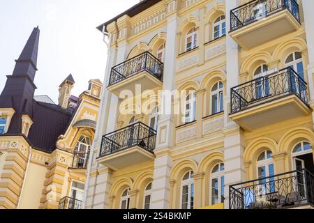 Yellow modern exterior of houses buildings. Windows balcony facade. Bright architecture street Stock Photo