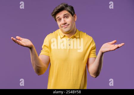 Confused casual 30s aged man, shoulders up - can't help, makes gesture of I dont know. Difficult question, guilty reaction, puzzled stylish guy on vio Stock Photo