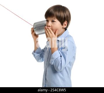 Boy using tin can telephone on white background Stock Photo