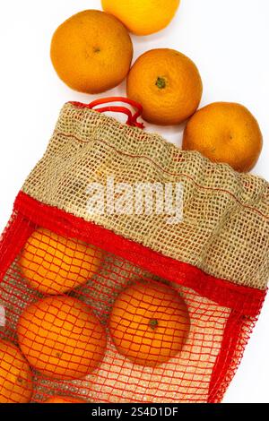 Delicious mandarins in a jute bag on a white background Stock Photo