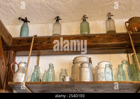 Old glass bottles on a shelf. Retro antique syphon bottles Stock Photo
