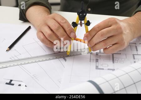 Architect working with project, closeup. Different technical drawings on table Stock Photo