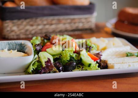 A Fresh Salad Platter with Hummus and Bread delights the palate Stock Photo