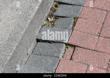 sunken paving stones along an edge need repair Stock Photo
