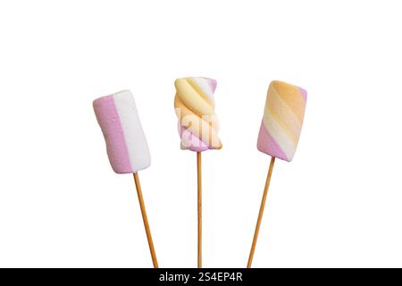 Three pastel colored marshmallows on wooden skewers, close up isolated on white Stock Photo
