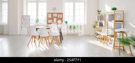 Modern bright and spacious office interior with organized open space and empty conference room. Stock Photo