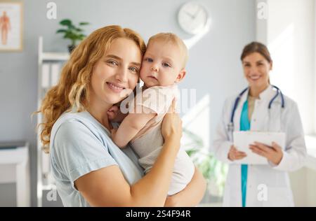 Portrait of a happy healthy young mother and her little baby at a pediatric clinic Stock Photo