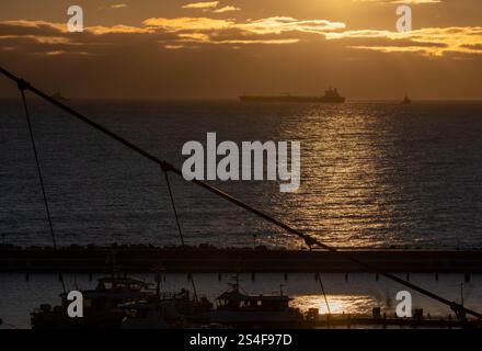 Sassnitz, Germany. 12th Jan, 2025. The unmaneuverable tanker "Eventin" is moored in the Sassnitz roadstead between Binz and Sassnitz at sunrise. The tanker, loaded with around 99,000 tons of oil, is to remain there until a decision is made on how to proceed. Credit: Stefan Sauer/dpa/Alamy Live News Stock Photo