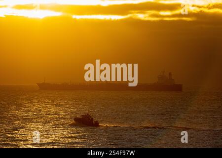 Sassnitz, Germany. 12th Jan, 2025. The unmaneuverable tanker "Eventin" is moored in the Sassnitz roadstead between Binz and Sassnitz at sunrise. The tanker, loaded with around 99,000 tons of oil, is to remain there until a decision has been made on how to proceed. Credit: Stefan Sauer/dpa/Alamy Live News Stock Photo