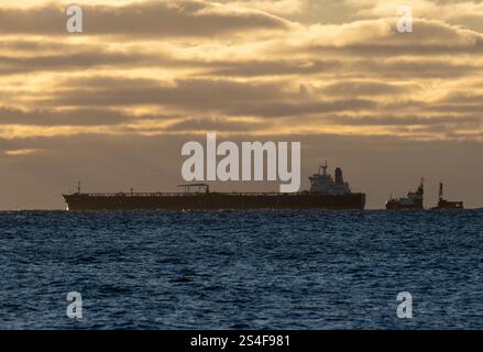 Sassnitz, Germany. 12th Jan, 2025. The unmaneuverable tanker "Eventin" is moored in the Sassnitz roadstead between Binz and Sassnitz at sunrise. The tanker, loaded with around 99,000 tons of oil, is to remain there until a decision is made on how to proceed. Credit: Stefan Sauer/dpa/Alamy Live News Stock Photo