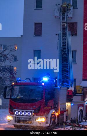 Winter rescue operation in an apartment building, fire truck with a ...