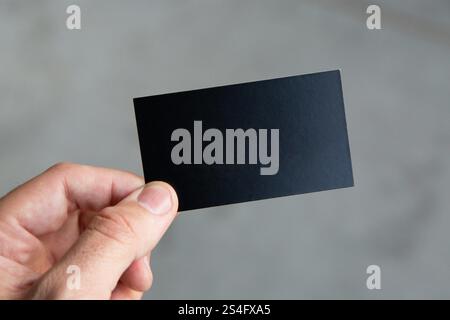 person holding black rectangular business card. Stock Photo