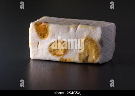 piece of nougat candy on black background Stock Photo