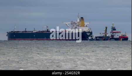 Sassnitz, Germany. 12th Jan, 2025. The unmaneuverable tanker "Eventin" is lying in the Sassnitz roadstead between Binz and Sassnitz. The tanker, loaded with around 99,000 tons of oil, is to remain there until a decision has been made on how to proceed. The multi-purpose vessel "Arkon" from the Stralsund Waterways and Shipping Office is observing the tanker Credit: Stefan Sauer/dpa/Alamy Live News Stock Photo
