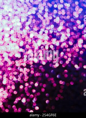 A bokeh effect photograph, out of focus lights creating a pink circles texture background Stock Photo