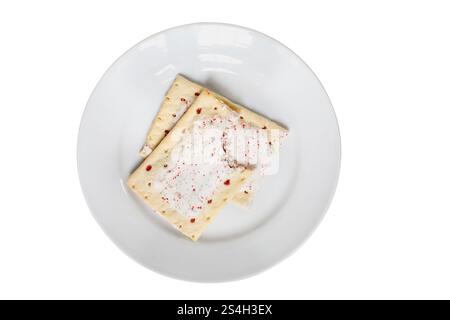 Delicious strawberry tarts ready to pop in the toaster for a treat or breakfast. Top pastry has bite missing. Isolated over white with clipping path. Stock Photo