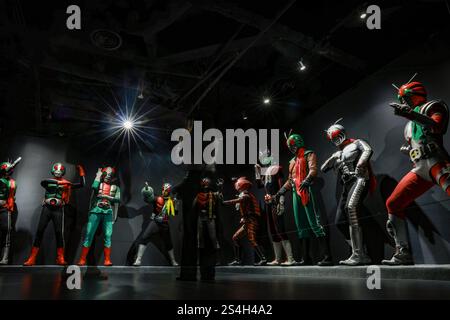 A fan of the Kamen Rider drama series takes a selfie with the Kamen ...