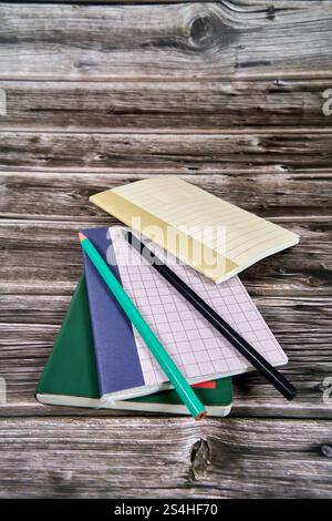 Notebooks and stationery placed on wooden table.  Stock Photo