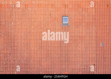 Aerial view of orange roof top and roof window with marks of moss Stock Photo