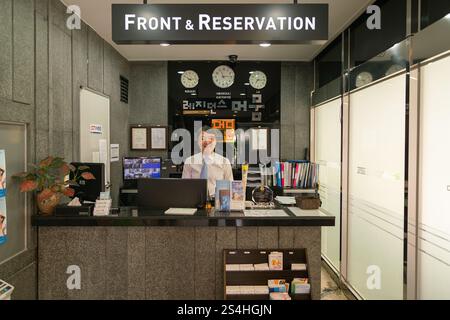 Busan, South Korea - May 29, 2017: a man stands behind the reception desk at Residence Mumum Hotel in Busan. Stock Photo