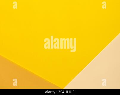 Bright yellow, beige, and orange paper background with bold, diagonal translucent layers. Vibrant and multicolored, the geometric composition is dynam Stock Photo