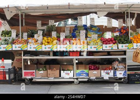 colorful sidewalk fruit and vvegetable stand on a new york street, a variety of fruits displayed with price signs Stock Photo