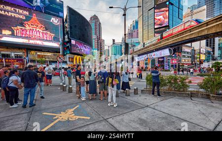 People wait for green light at the pedestrian crossing at the intersection of Jalan Bukit Bintang and Jalan Sultan Ismail in Kuala Lumpur, Malaysia. Stock Photo