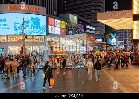 People walk at the fountain in front of The Pavilion, a luxury shopping centre in Bukit Bintang district. Kuala Lumpur, Malaysia. Stock Photo