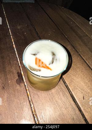 Whiskey Sour cocktail in a round glass on a table. Flashlight Stock Photo