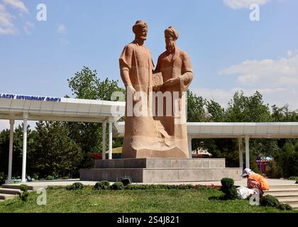 A gardener at the Alisher Navoi & Abdurakhman Jami monument in Central Park, Samarkand, a historic and prominent cultural landmark in Uzbekistan Stock Photo