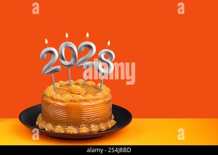 Candle number 2028 for happy new year - New years eve celebration on orange background Stock Photo