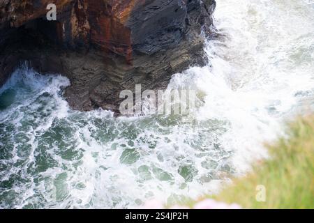 Telephoto view of Ballybunion's Men's Beach, County Kerry, Ireland, featuring cliffs, sandy shores, turquoise waters, and a vivid blue sky. Stock Photo