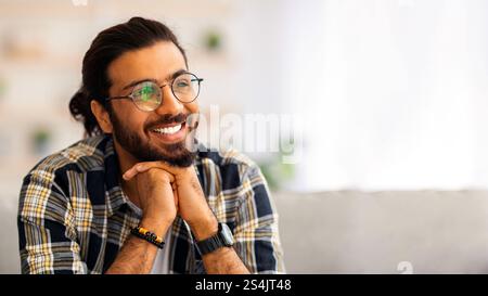 Handsome millennial arab man resting at home Stock Photo