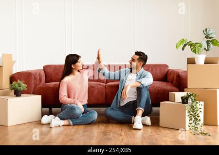 Happy man and woman giving high five Stock Photo