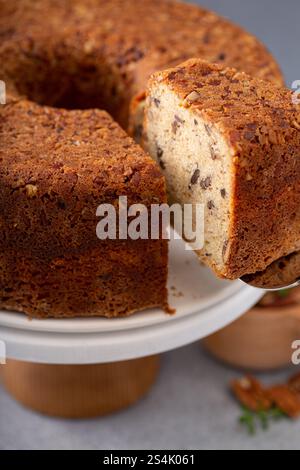 Pecan caramel pound cake baked in a bundt pan, homemade and served on a cake stand sliced Stock Photo