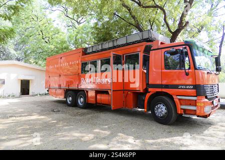 Madurai, South India, India, Asia, Big orange tour bus on a forested car park, Impressions from South India, Thanjavur, Kovalam, Malabar Coast, Malaba Stock Photo