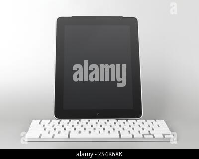 Apple iPad 3G tablet computer with a keyboard dock accessory isolated on gray background Stock Photo