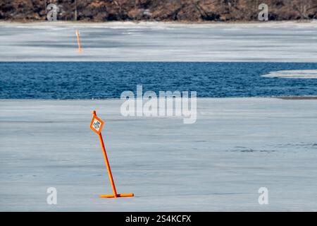 Little Canada; Minnesota. Gervais Park. Thin ice sign on aerated pond in the winter. It is aerated to enhance natural oxygenation in the pond. Stock Photo