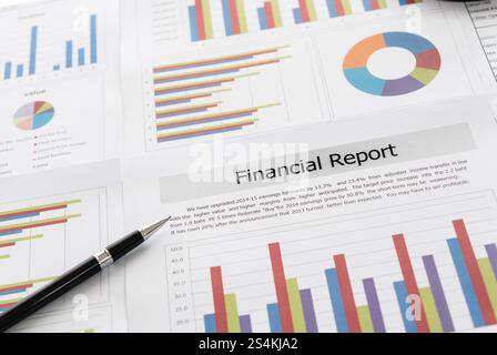 Financial graphs and charts report with pen, magnifying glass on desk of business advisor. financial and accounting report concepts. Stock Photo