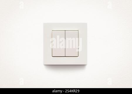 Cream colored wall mounted cream colored double light switch Stock Photo